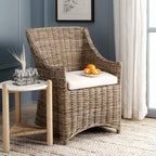 Poltrona in rattan con cuscino in cotone