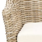 Poltrona in rattan con cuscino in cotone